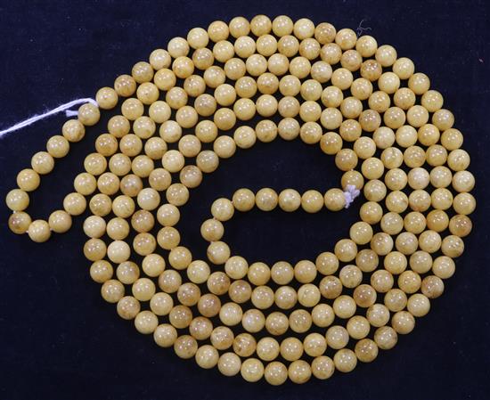 A single strand spherical amber bead necklace, 168cm.